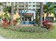 Beautiful entrance with a fountain, lovely landscaping, and inviting access to the building at 140 Riviera Dunes Way # 404, Palmetto, FL 34221