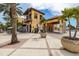Striking two-story commercial building with a beautiful entry, palm trees, and outdoor seating at 140 Riviera Dunes Way # 404, Palmetto, FL 34221