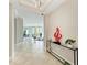 Open foyer featuring tile flooring and views into dining and living spaces at 140 Riviera Dunes Way # 404, Palmetto, FL 34221