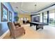This game room has a pool table, comfortable seating, and ample space for entertainment and relaxation at 140 Riviera Dunes Way # 404, Palmetto, FL 34221