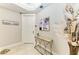 Hallway featuring neutral decor, accent table with art, and access to living spaces at 140 Riviera Dunes Way # 404, Palmetto, FL 34221