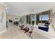 Bright living room with tile floors, modern furnishings, and sliding glass doors leading to a balcony with a view at 140 Riviera Dunes Way # 404, Palmetto, FL 34221