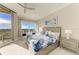 Bright main bedroom featuring balcony access and views of the city from the large window at 140 Riviera Dunes Way # 404, Palmetto, FL 34221