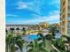 An aerial view showcases a pool, lush landscaping, and a marina in this beautiful community at 140 Riviera Dunes Way # 404, Palmetto, FL 34221