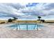 A stunning rooftop pool offers a luxurious amenity with comfortable lounge chairs and clear, sunny skies at 140 Riviera Dunes Way # 404, Palmetto, FL 34221