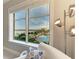 Picturesque views of the marina, pools, and palm trees from a comfortable chair at 140 Riviera Dunes Way # 404, Palmetto, FL 34221