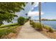 Scenic community walking path featuring waterfront views and lush landscaping, perfect for a stroll at 140 Riviera Dunes Way # 404, Palmetto, FL 34221