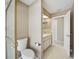 Bright bathroom featuring a toilet, vanity with cabinets, and tiled floors at 14048 Bruni Dr, Spring Hill, FL 34609