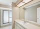 Bathroom featuring a vanity with a large mirror and a glass-enclosed shower for a modern touch at 14048 Bruni Dr, Spring Hill, FL 34609