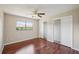 Brightly lit bedroom with a ceiling fan, a pair of closets, and a large picture window at 14048 Bruni Dr, Spring Hill, FL 34609