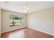 Bright bedroom featuring a large window offering plenty of natural light and wood flooring at 14048 Bruni Dr, Spring Hill, FL 34609