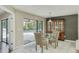 Bright dining area with pool view and a classic china cabinet, adjacent to the kitchen at 14048 Bruni Dr, Spring Hill, FL 34609