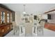 Bright dining area with tiled floors and a view into the kitchen and the fireplace area at 14048 Bruni Dr, Spring Hill, FL 34609