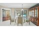 Bright dining area with pool views, tiled floors, adjacent to the kitchen, and a china cabinet at 14048 Bruni Dr, Spring Hill, FL 34609