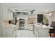 Spacious kitchen with stainless steel appliances, white cabinets and a sink beneath the window at 14048 Bruni Dr, Spring Hill, FL 34609