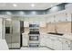 Updated kitchen featuring stainless steel appliances, sleek countertops, and ample cabinet space at 14048 Bruni Dr, Spring Hill, FL 34609