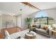 Bright living room featuring a large arched window, wood floors, and stylish, neutral-toned furnishings at 14048 Bruni Dr, Spring Hill, FL 34609