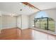 Bright living room featuring a large arched window and beautiful wood floors at 14048 Bruni Dr, Spring Hill, FL 34609