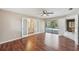 Main bedroom featuring a bathroom, a door to the outside pool, and wood flooring at 14048 Bruni Dr, Spring Hill, FL 34609