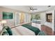 Main bedroom featuring a bathroom, a door to the outside pool, and wood flooring at 14048 Bruni Dr, Spring Hill, FL 34609