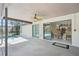 Covered patio with ceiling fan overlooking the pool and a view inside to the dining area and kitchen at 14048 Bruni Dr, Spring Hill, FL 34609
