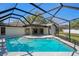 Inviting screened-in pool area featuring a sparkling pool and a spacious outdoor patio for relaxation at 14048 Bruni Dr, Spring Hill, FL 34609