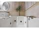 Relaxing bathroom featuring a large jacuzzi tub, decorative wood paneling, and modern fixtures at 16 N Saturn Ave, Clearwater, FL 33755