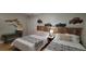 Comfortable bedroom with two twin beds, rustic wood decor, and ample closet space at 16 N Saturn Ave, Clearwater, FL 33755