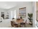 Bright dining area features a wooden table, stylish chairs, and natural light, creating a cozy and inviting space at 19632 Fort King Run, Brooksville, FL 34601