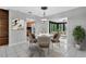 Bright dining room features a modern chandelier and flows seamlessly into the kitchen and sunroom at 205 Sheryl Lynn Dr, Brandon, FL 33510