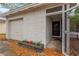 Close up view of the front entrance with a garage and flower bed at 205 Sheryl Lynn Dr, Brandon, FL 33510