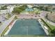 Aerial view of a community with tennis courts, parking, and meticulously maintained green spaces at 2379 Finlandia Ln # 21, Clearwater, FL 33763