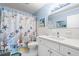 Cozy bathroom featuring blue walls and a stylish shower curtain at 2379 Finlandia Ln # 21, Clearwater, FL 33763