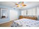 Bright bedroom with wood-look flooring, rattan dressers, leaf fan, and blue walls at 2379 Finlandia Ln # 21, Clearwater, FL 33763