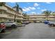 A view of the building's parking lot featuring ample space and access to the condo with a covered entryway at 2379 Finlandia Ln # 21, Clearwater, FL 33763