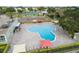 Large community pool with lounge chairs, umbrellas, and well-maintained landscaping at 2379 Finlandia Ln # 21, Clearwater, FL 33763