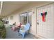 Charming front porch with colorful chairs, decorative door, and a welcoming, cozy ambiance at 2379 Finlandia Ln # 21, Clearwater, FL 33763