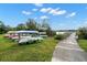 Outdoor kayak storage rack with a variety of kayaks near a wooden dock and lush greenery at 2379 Finlandia Ln # 21, Clearwater, FL 33763