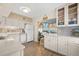 Bright kitchen with white cabinetry, modern appliances, backsplash detail, and wood-look flooring at 2379 Finlandia Ln # 21, Clearwater, FL 33763
