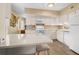 Bright kitchen featuring white cabinetry, countertop seating, modern appliances, and wood-look flooring at 2379 Finlandia Ln # 21, Clearwater, FL 33763