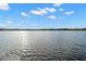 Serene lake view from the wooden dock with sparkling water and clear blue sky at 2379 Finlandia Ln # 21, Clearwater, FL 33763