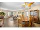 Combined living and dining area with a spacious layout, wood-look floors, and cozy decor at 2379 Finlandia Ln # 21, Clearwater, FL 33763