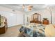 Bright main bedroom with wood-look flooring, leaf fan, and closet storage at 2379 Finlandia Ln # 21, Clearwater, FL 33763