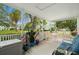 Covered porch with patio furniture and views of the lush, landscaped surroundings at 2379 Finlandia Ln # 21, Clearwater, FL 33763