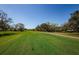 View of the lush green golf course with clear blue skies, providing an appealing outdoor recreational opportunity at 30 Woodridge Cir, Oldsmar, FL 34677