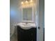 Bathroom vanity features a white countertop, dark wood cabinets, and a decorative mirror at 30142 Sotogrande Loop, Wesley Chapel, FL 33543