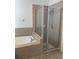 Bathroom showcasing a tiled shower and separate soaking tub with modern fixtures at 30142 Sotogrande Loop, Wesley Chapel, FL 33543