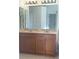 Bathroom with a double sink vanity with wood cabinets and marble countertops at 30142 Sotogrande Loop, Wesley Chapel, FL 33543