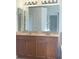Bathroom vanity with double sinks, granite counters, and ample lighting at 30142 Sotogrande Loop, Wesley Chapel, FL 33543