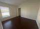 Bedroom with wood floors, window, and a closet provides natural light at 30142 Sotogrande Loop, Wesley Chapel, FL 33543